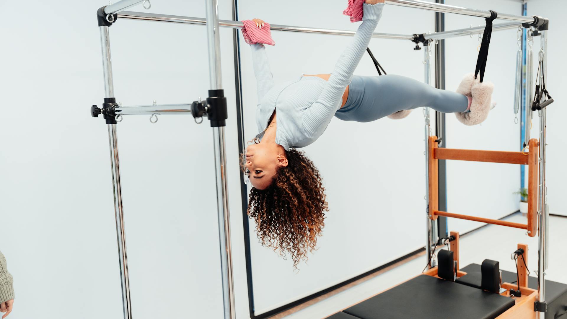 Woman doing Pilates in a bright studio